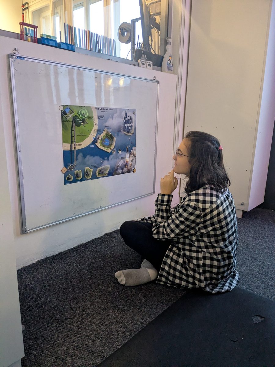 A player studying The Game of Life board inside the TwoFish environment.