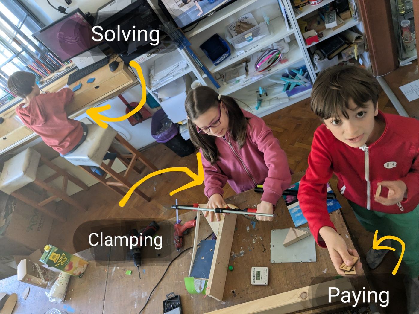 An older leader and a child working together at a TwoFish table.