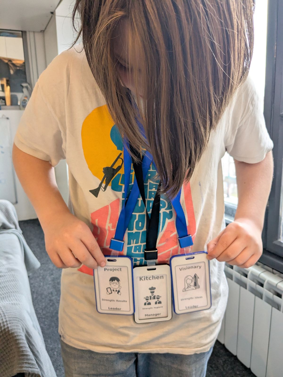 A child wearing multiple role badges inside the TwoFish environment.
