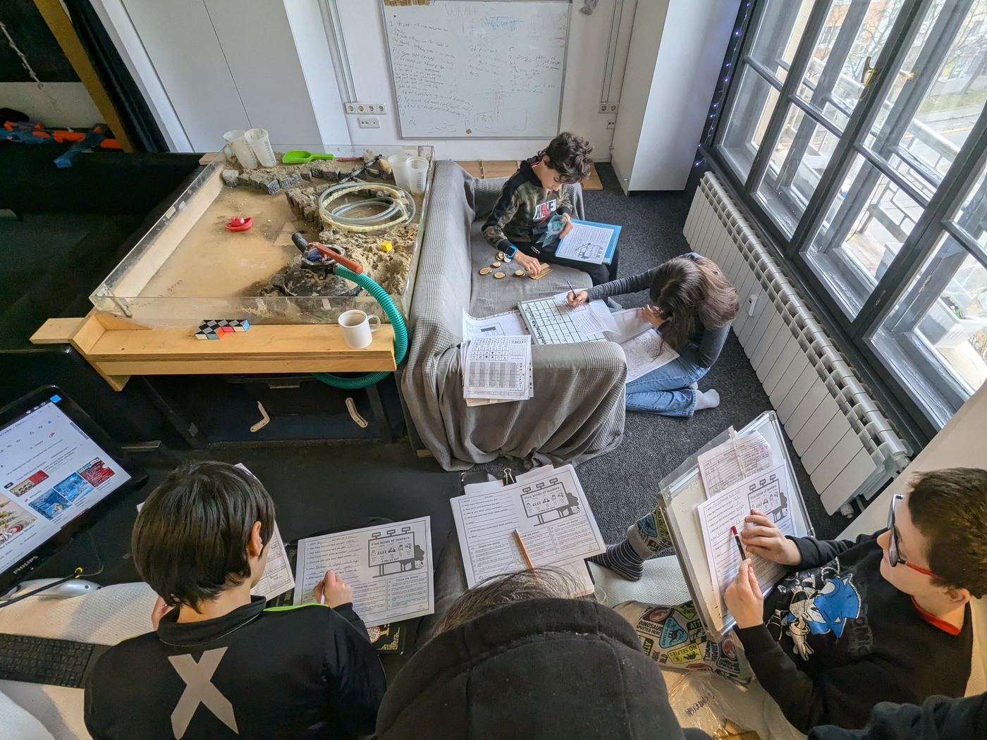 A trust-building TwoFish image showing children working inside a structured, supported environment.
